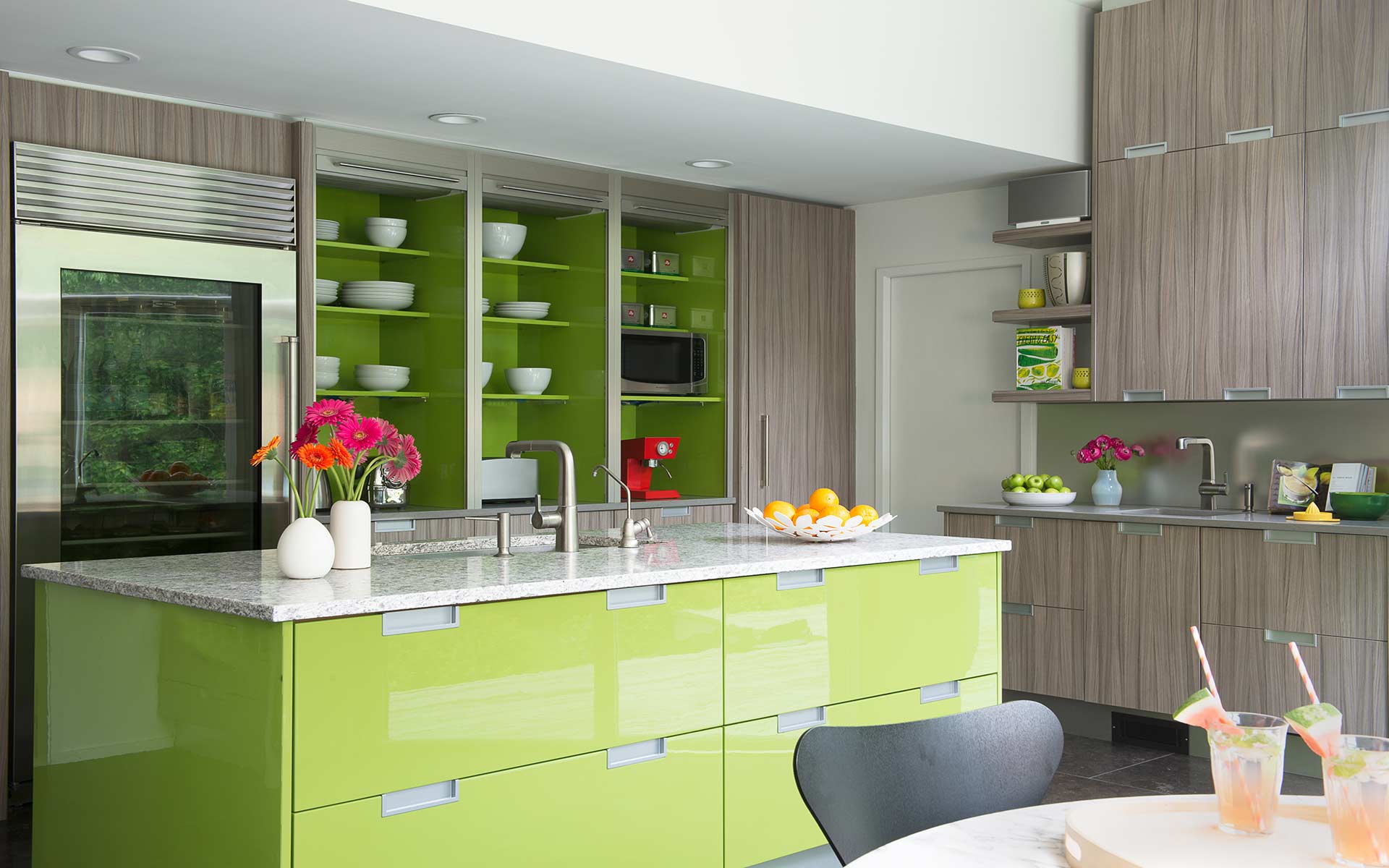 DEANE Inc custom lime green kitchen with custom cabinetry, custom built in shelving and stainless steel appliances.