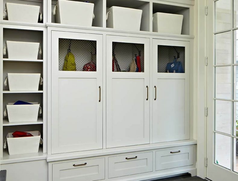 Custom cabinetry in this mudroom allows for maximum storage with its shelving.