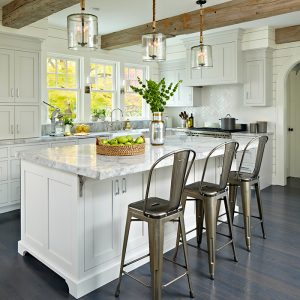 Contemporary kitchen designed by DEANE inc with custom cabinetry, custom countertops, wooden beams, and modern accents.